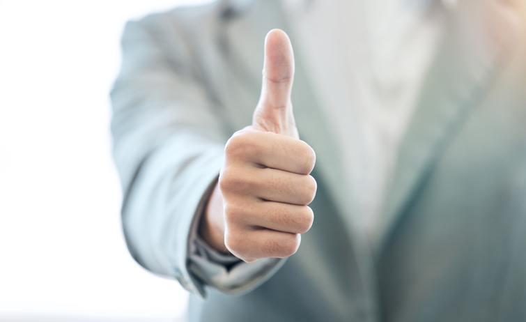 An image of a Triton customer giving a thumbs up for good service received.