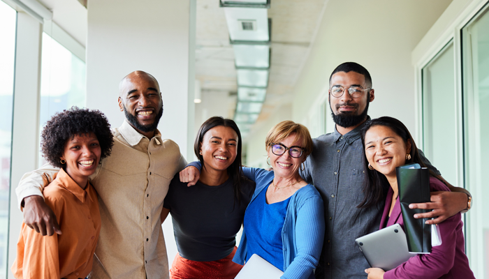 group of professionals standing arm in arm