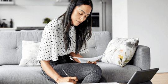 woman at home analyzing documents