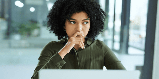 Girl in front on laptop looking at a criminal record check