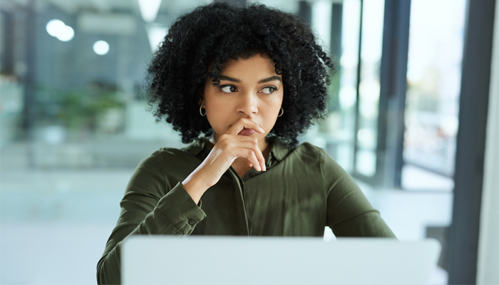 Girl in front on laptop looking at a criminal record check