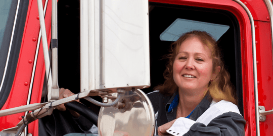 woman sitting in a big rig after getting her driving record abstract approved for the job