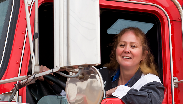 woman sitting in a big rig after getting her driving record abstract approved for the job