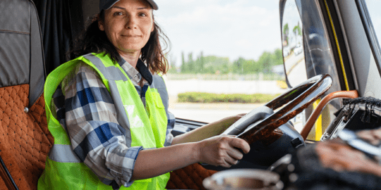 female truck driver at the wheel of a truck