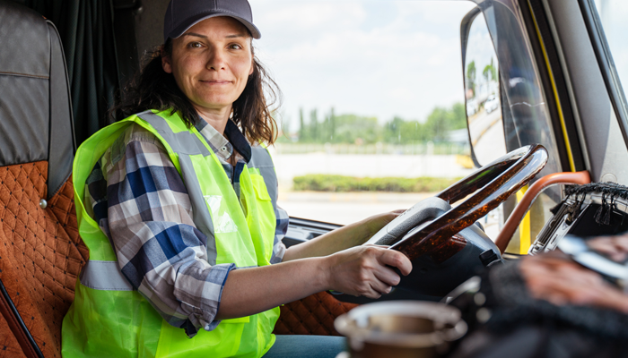 female truck driver at the wheel of a truck