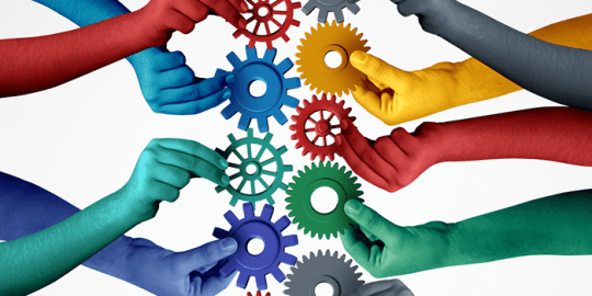 colourful hands holding cogwheels in the center showcasing bias hiring