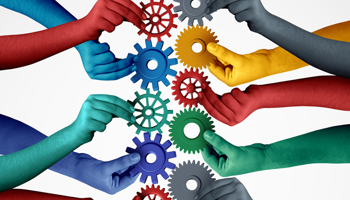 colourful hands holding cogwheels in the center showcasing bias hiring