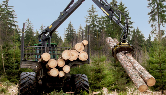 image of lumber being carried by machine showcasing employment screening for jobs in the forestry industry