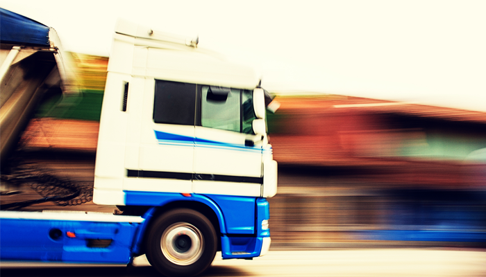 image of a big mac truck driving on highway